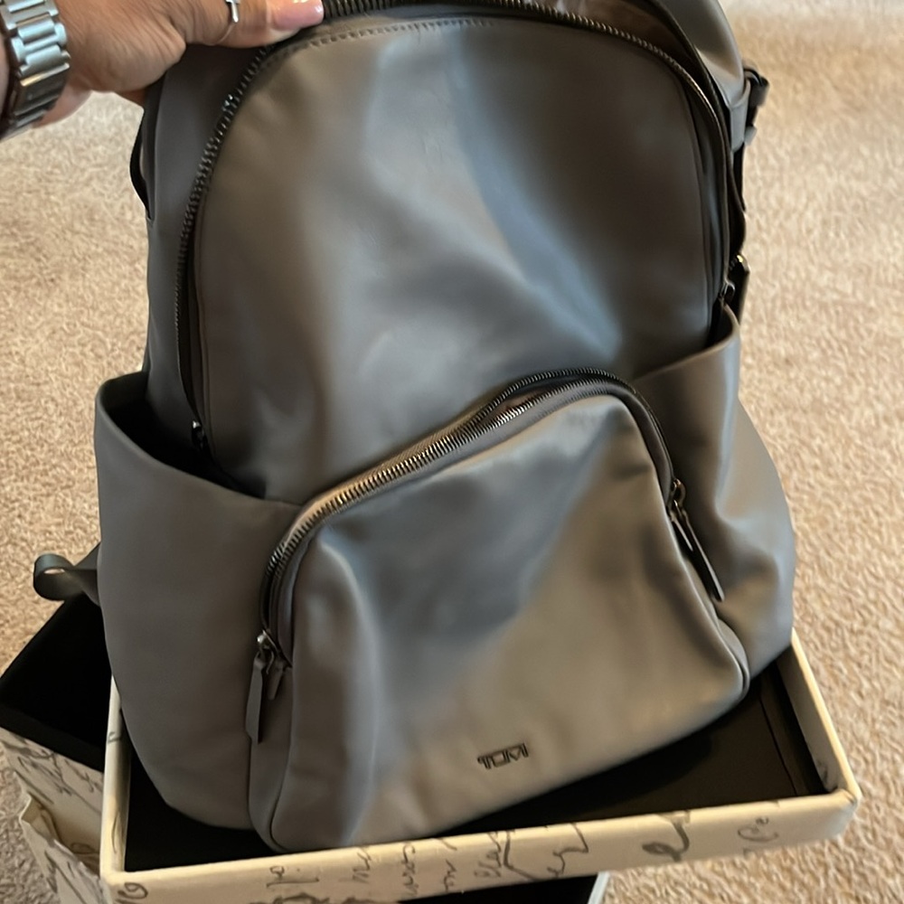 TUMI Grey Leayher backpack with neutral mauve interior and gunmetal accents